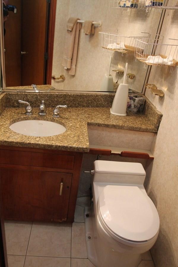 a bathroom with a sink and toilet aboard ENCHANTRESS Yacht for Sale
