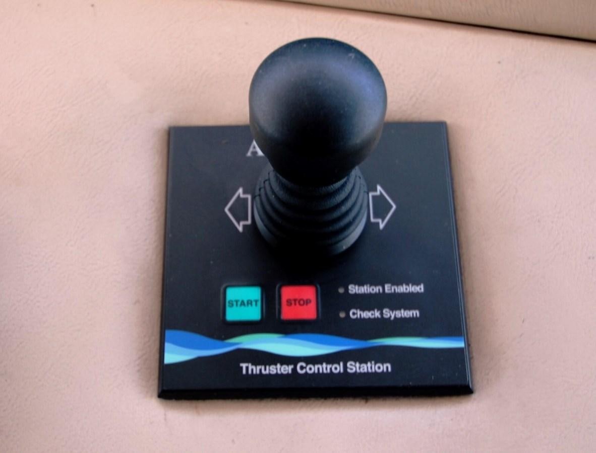 a black rectangular device with a red button and a white circle on a white surface aboard ENCHANTRESS Yacht for Sale