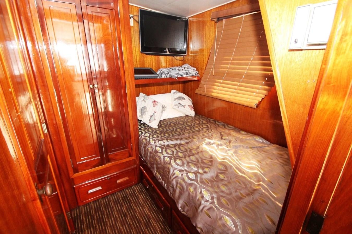 a bed in a room aboard ENCHANTRESS Yacht for Sale