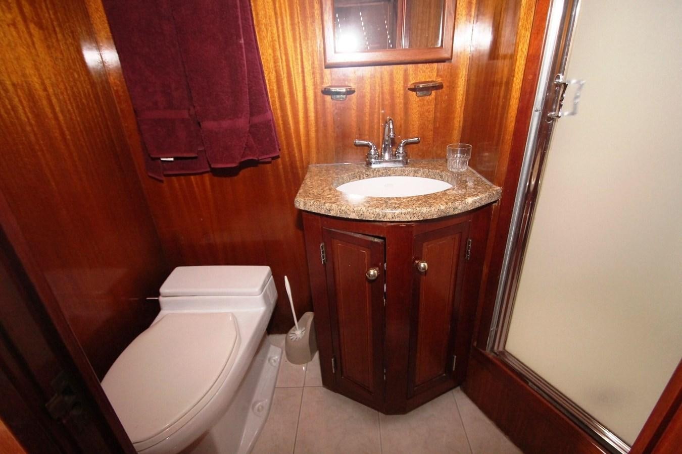 a bathroom with a toilet and sink aboard ENCHANTRESS Yacht for Sale