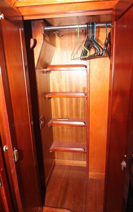 a wooden closet with a few items from it aboard ENCHANTRESS Yacht for Sale