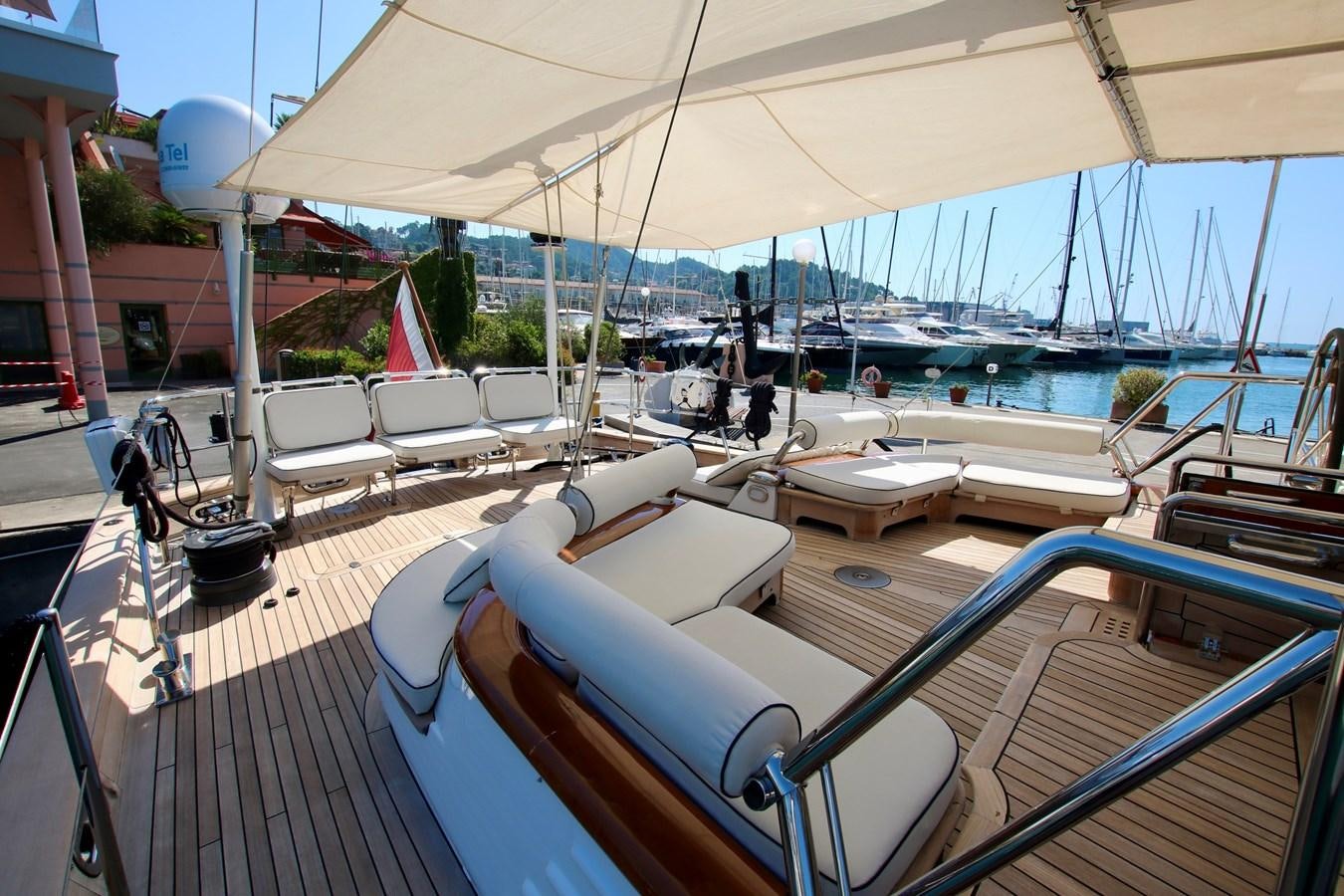 a deck with a boat and chairs aboard CYRANO DE BERGERAC Yacht for Sale
