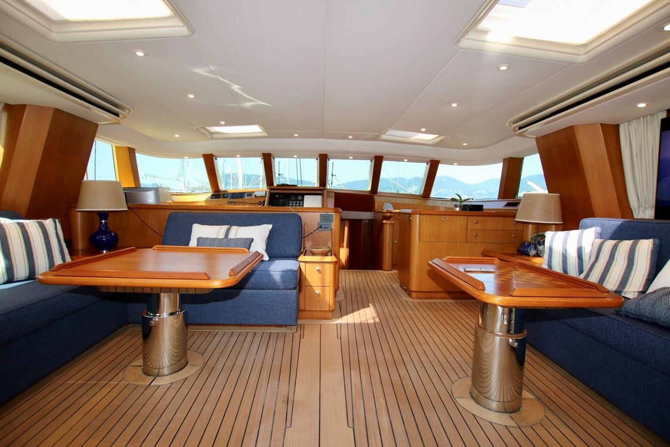 a living room with a couch and a table aboard CYRANO DE BERGERAC Yacht for Sale