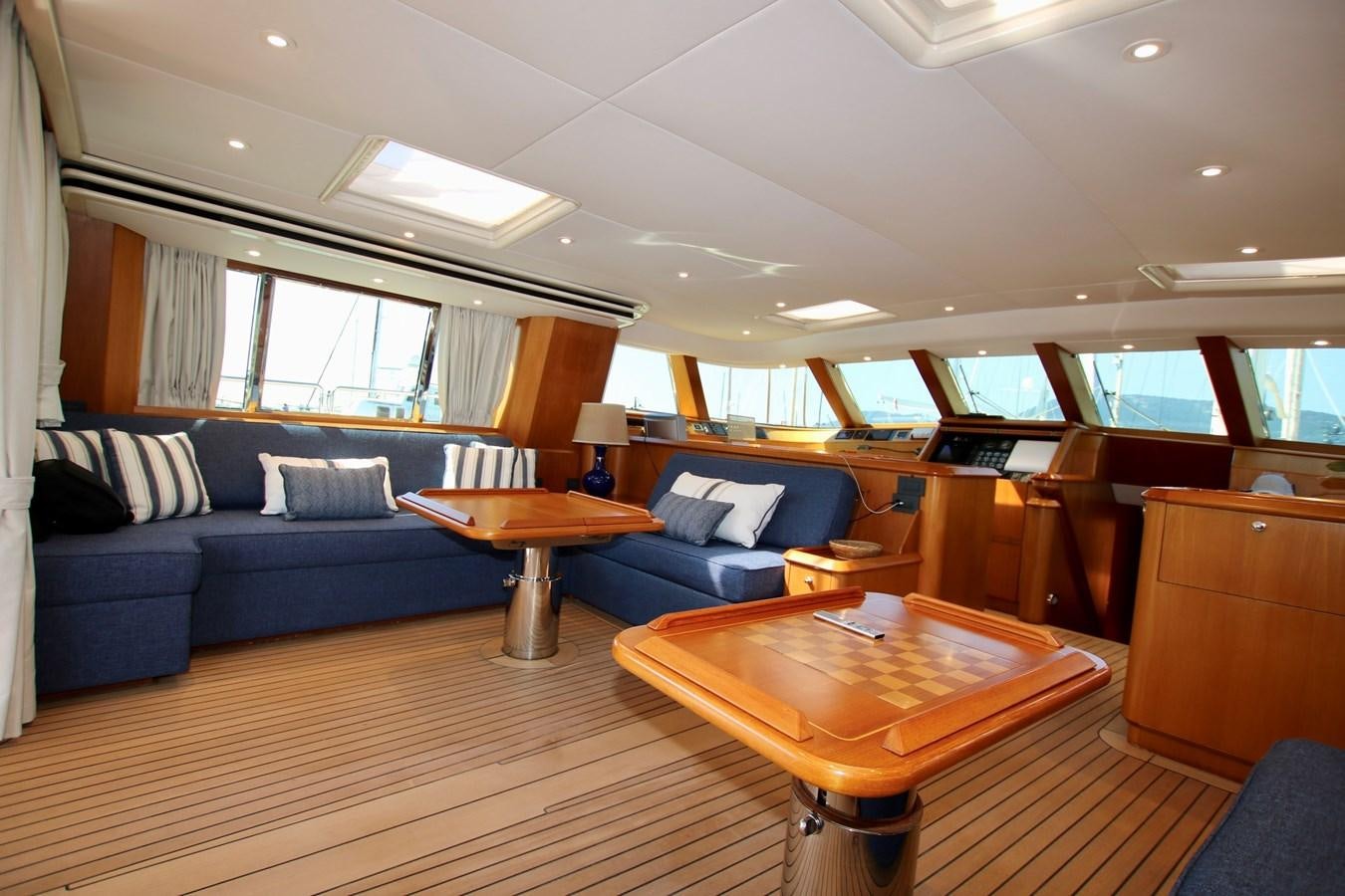 a room with a couch and a table aboard CYRANO DE BERGERAC Yacht for Sale