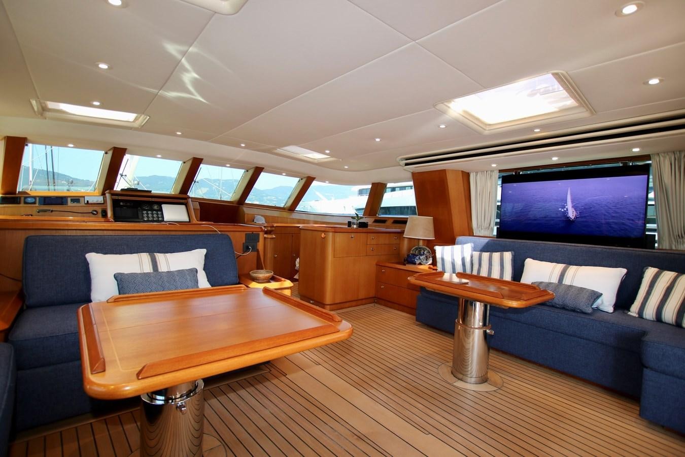 a room with a couch and a table and a television aboard CYRANO DE BERGERAC Yacht for Sale