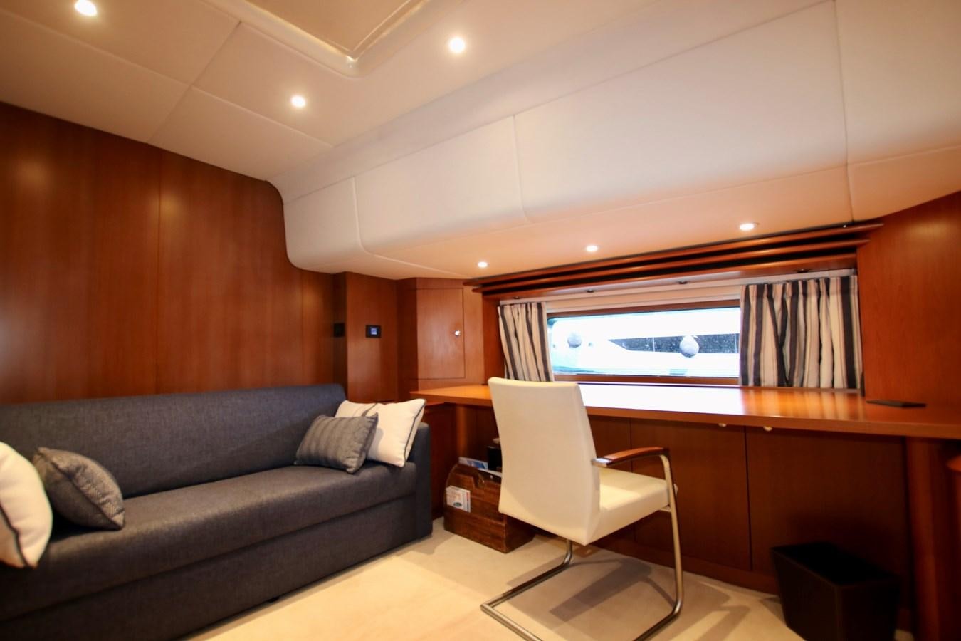 a living room with a couch and a tv aboard CYRANO DE BERGERAC Yacht for Sale