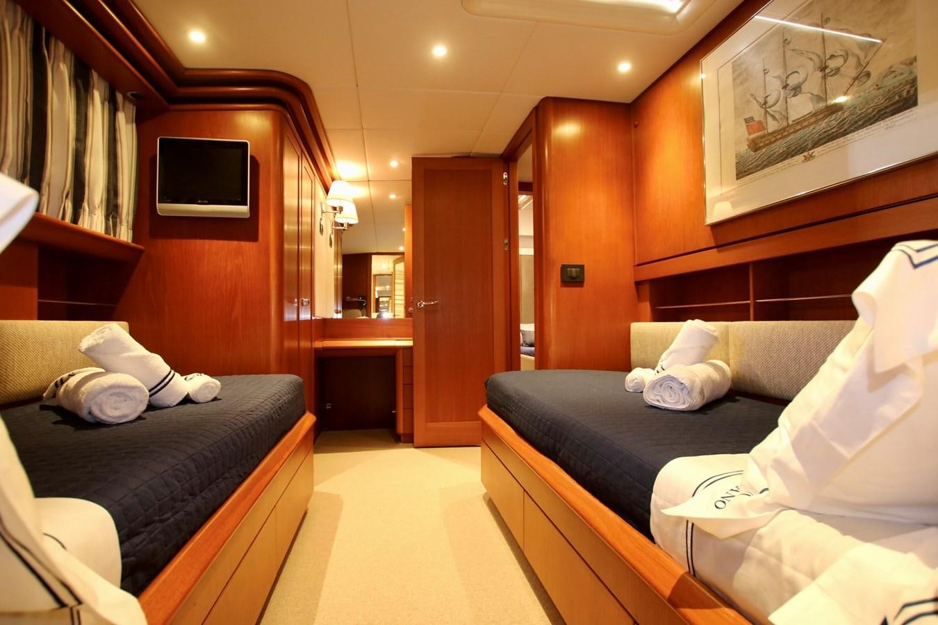a room with a bed and a television aboard CYRANO DE BERGERAC Yacht for Sale