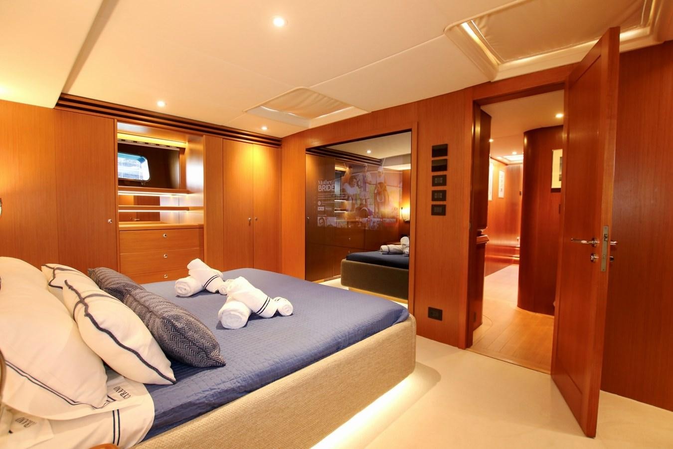 a bedroom with a bed and a door aboard CYRANO DE BERGERAC Yacht for Sale