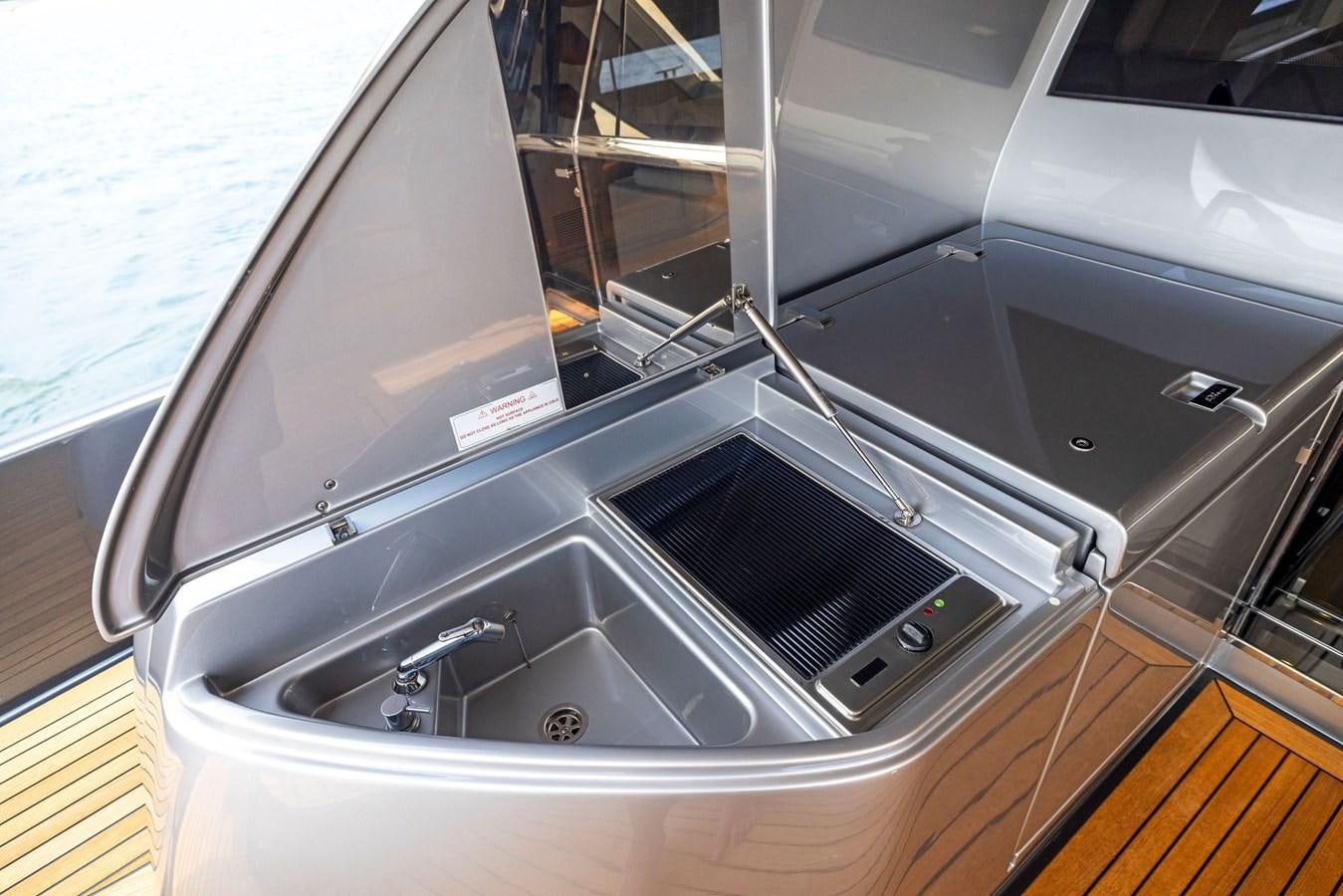 a silver car with a large screen aboard INDISCRETION Yacht for Sale