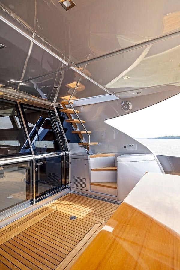 a room with a staircase and a wood floor aboard INDISCRETION Yacht for Sale