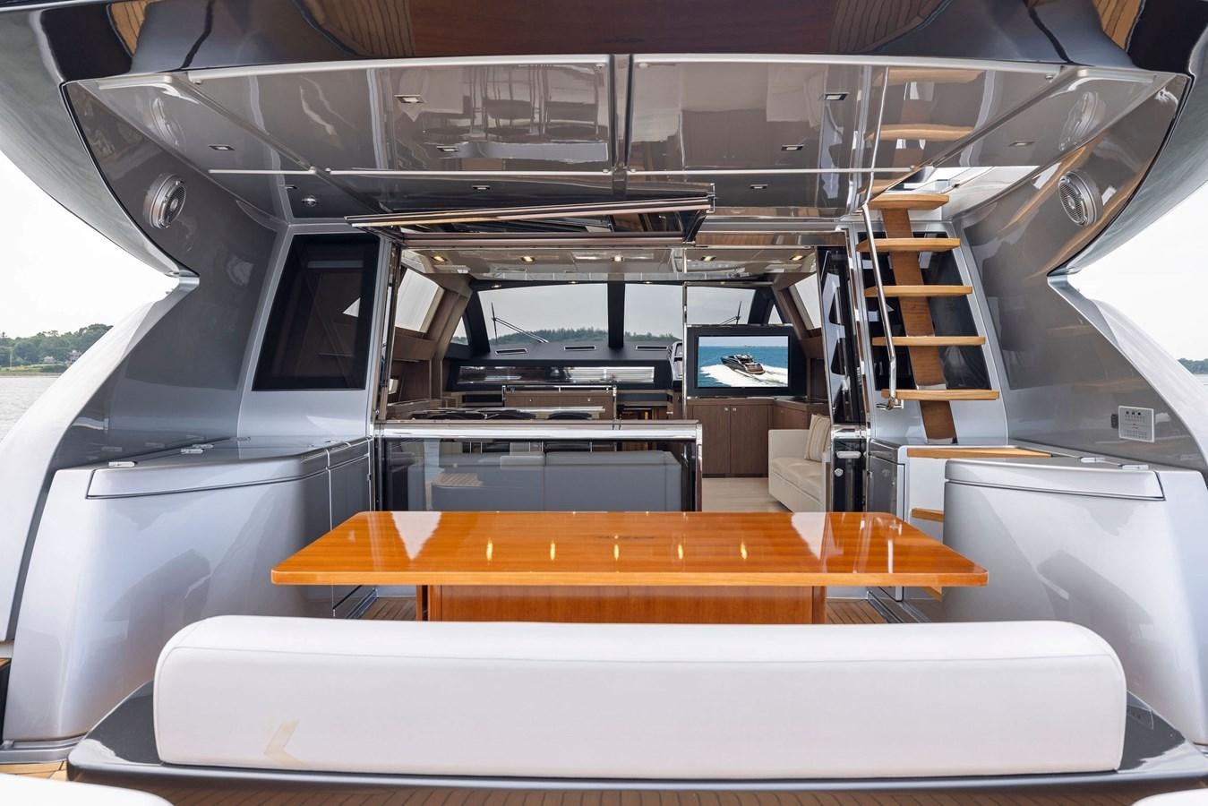 a room with a table and a shelf with books on it aboard INDISCRETION Yacht for Sale