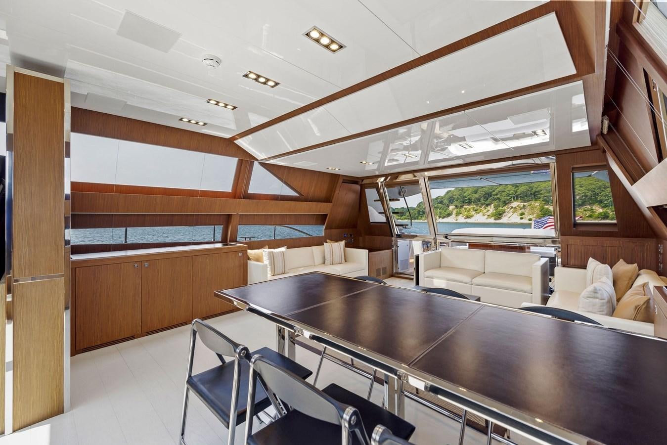 a kitchen with a bar and a table aboard INDISCRETION Yacht for Sale