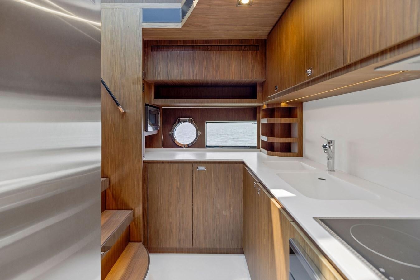 a kitchen with wooden cabinets aboard INDISCRETION Yacht for Sale