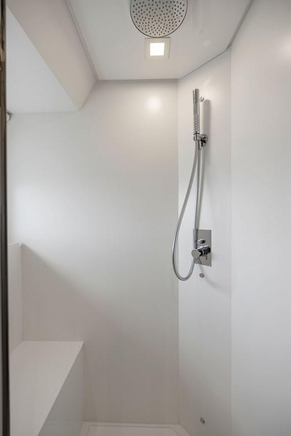 a shower head in a white room aboard INDISCRETION Yacht for Sale
