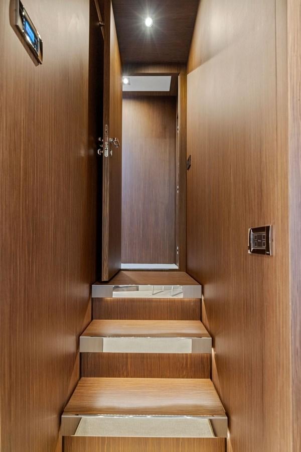 a wooden staircase with a wood door aboard INDISCRETION Yacht for Sale