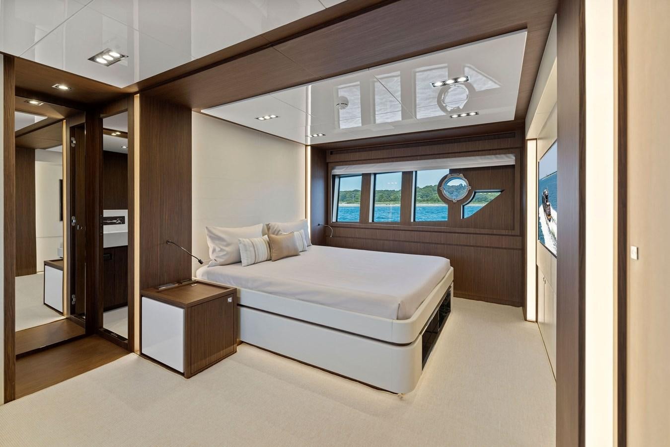 a room with a bed and a desk aboard INDISCRETION Yacht for Sale