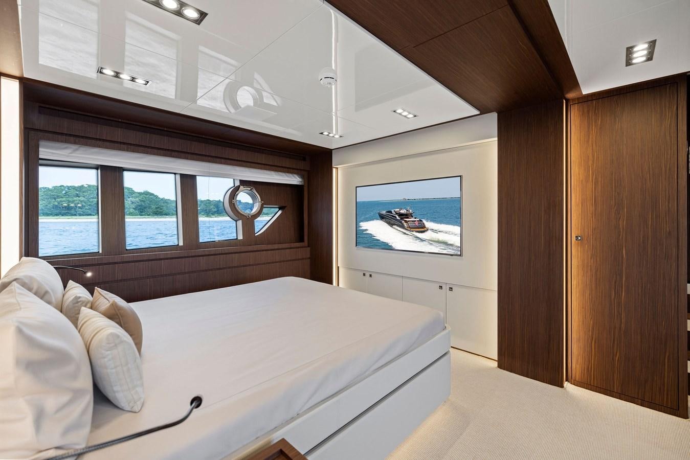 a bedroom with a large window aboard INDISCRETION Yacht for Sale
