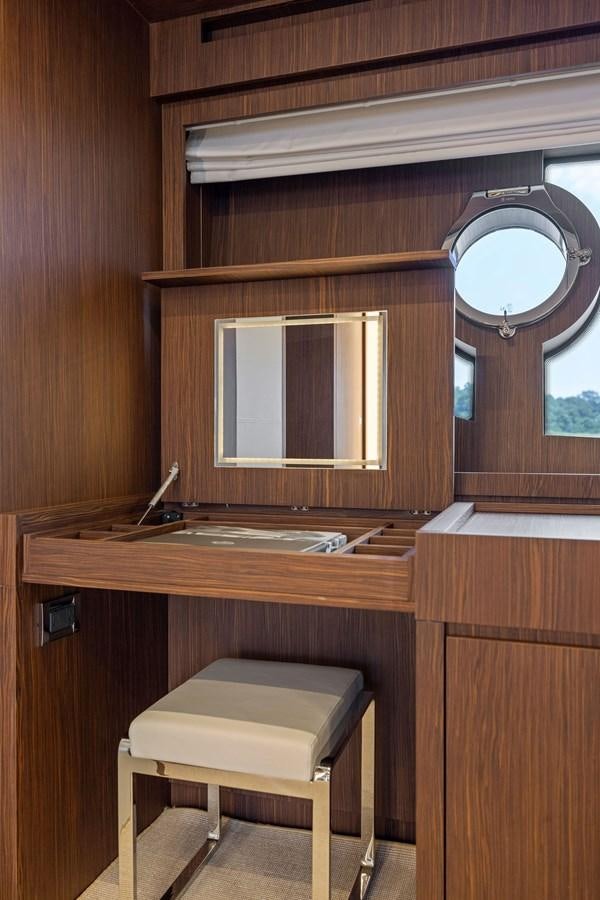 a wooden cabin with a round window aboard INDISCRETION Yacht for Sale