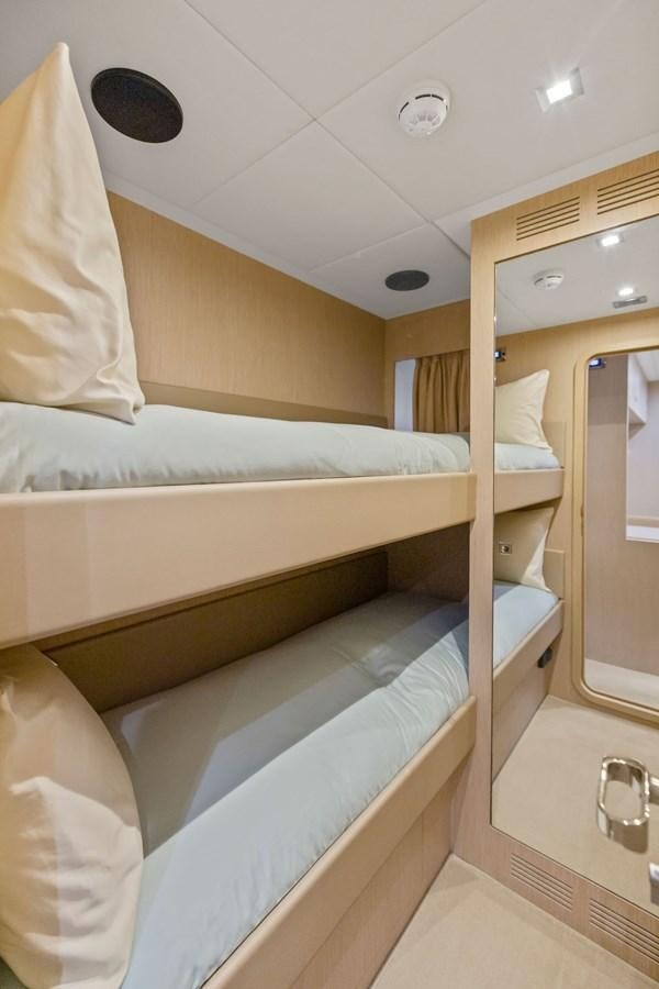 a room with a bed and a mirror aboard INDISCRETION Yacht for Sale
