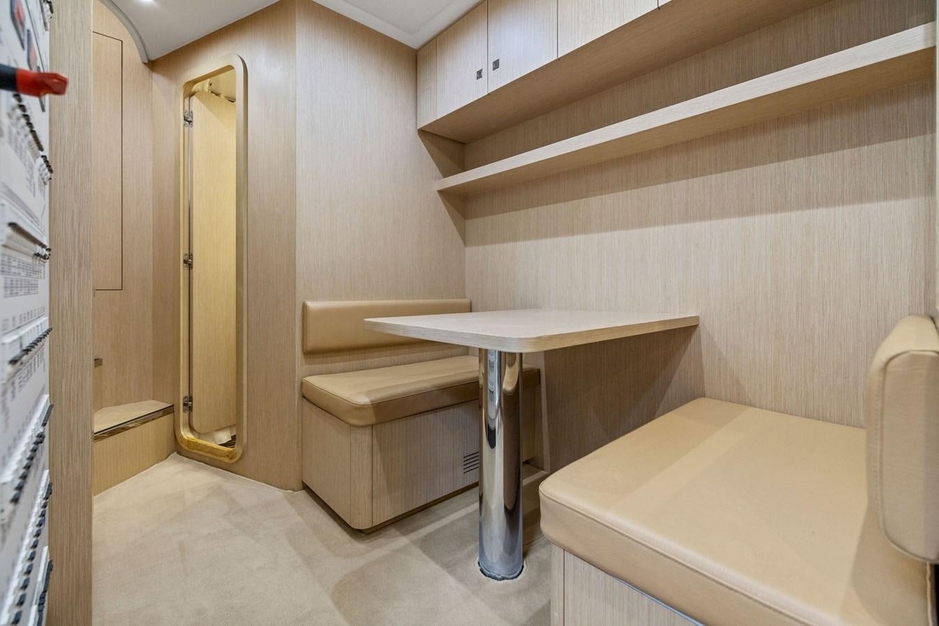 a table and bench in a room aboard INDISCRETION Yacht for Sale