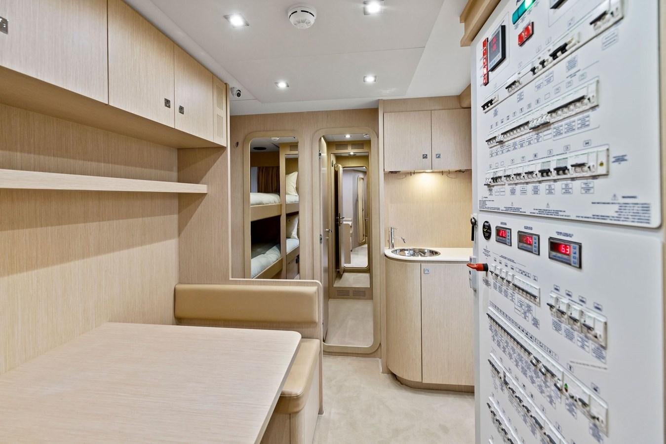 a kitchen with a refrigerator and a table aboard INDISCRETION Yacht for Sale