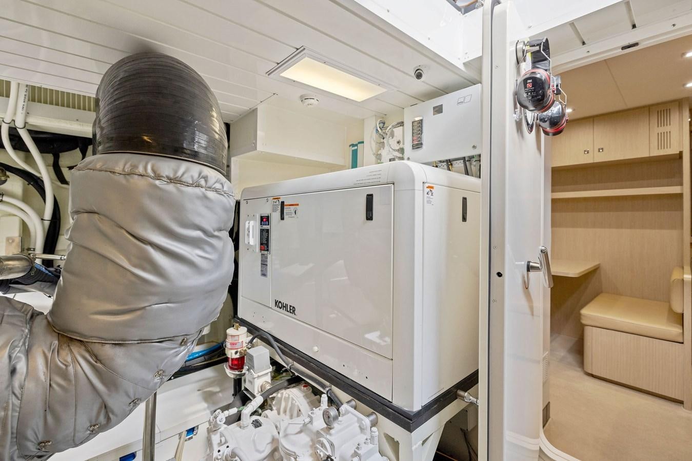a person in a mask looking at a refrigerator aboard INDISCRETION Yacht for Sale
