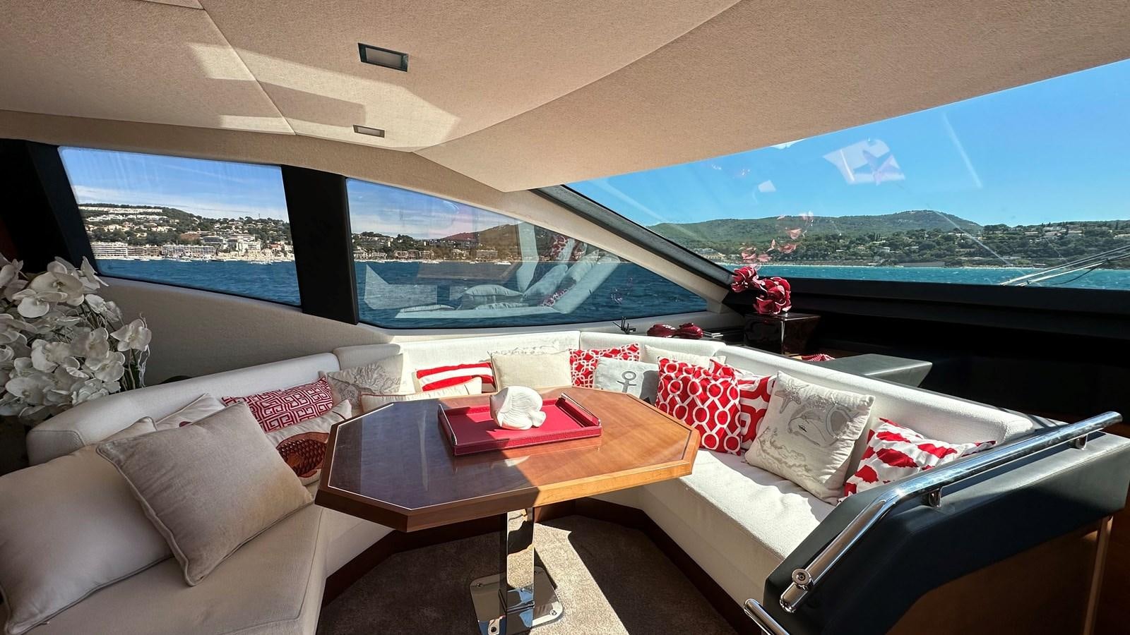 a room with a table and chairs aboard EVA Yacht for Sale