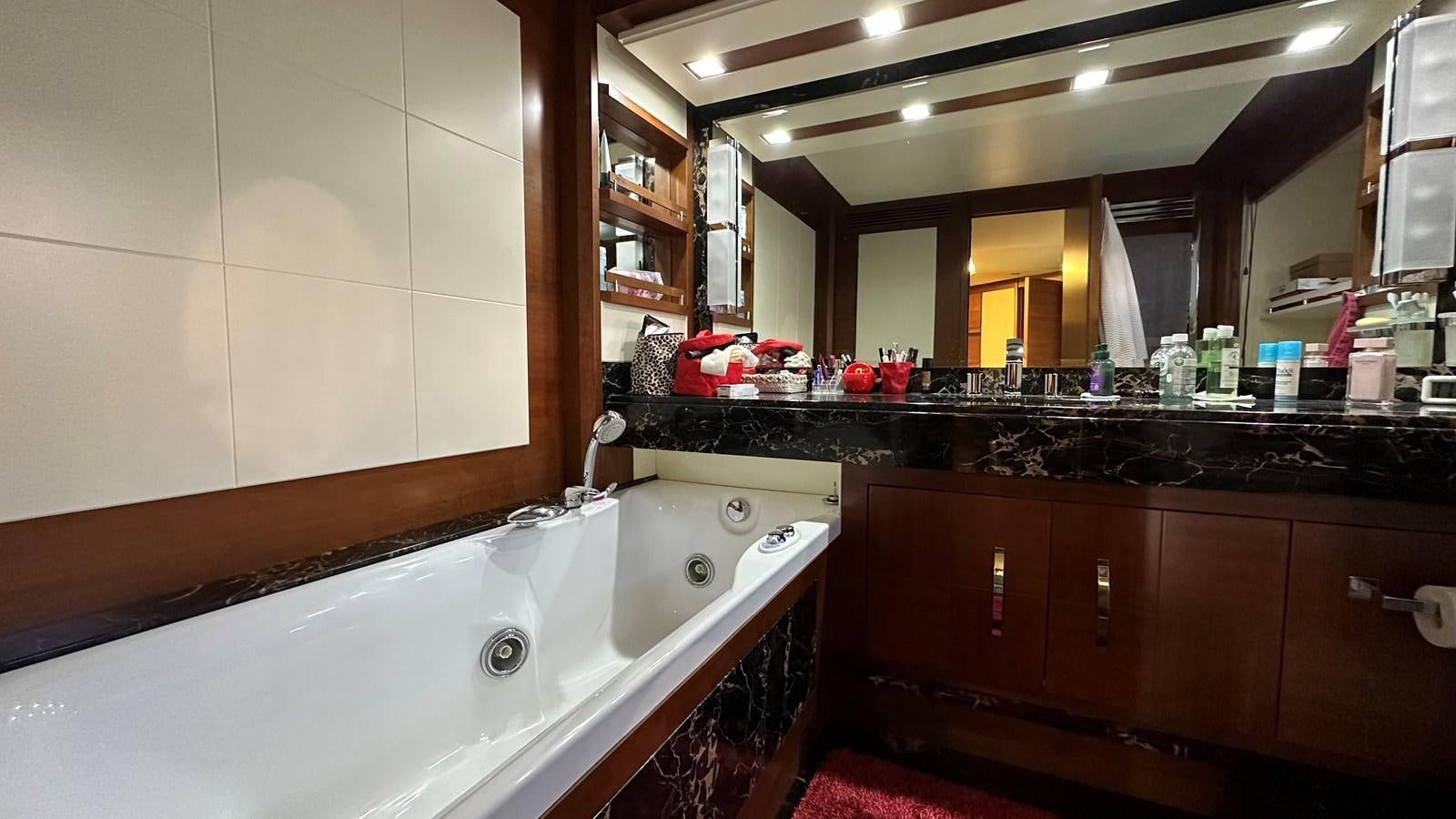 a large bathroom with a large bathtub aboard EVA Yacht for Sale