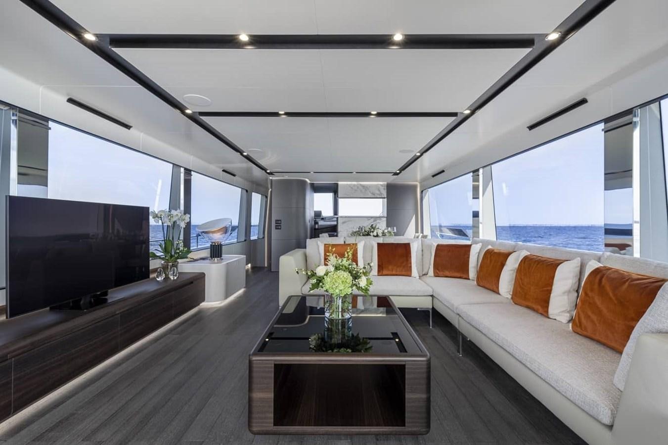 a living room with a large window aboard ASTO82AS8724 Yacht for Sale