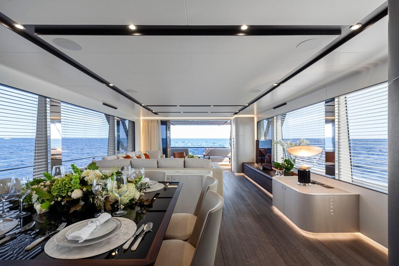 a large room with a table and chairs and a large window aboard ASTO82AS8724 Yacht for Sale