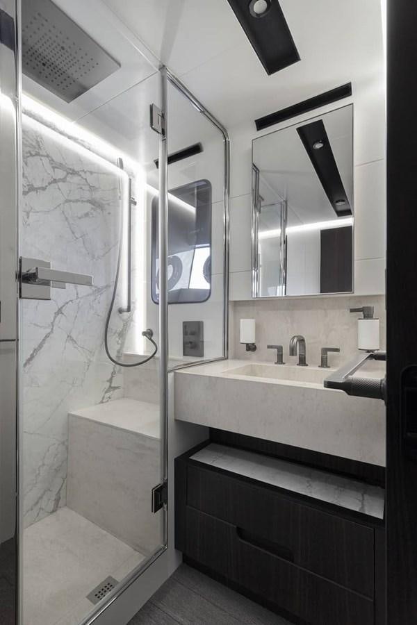 a bathroom with a sink and a mirror aboard ASTO82AS8724 Yacht for Sale
