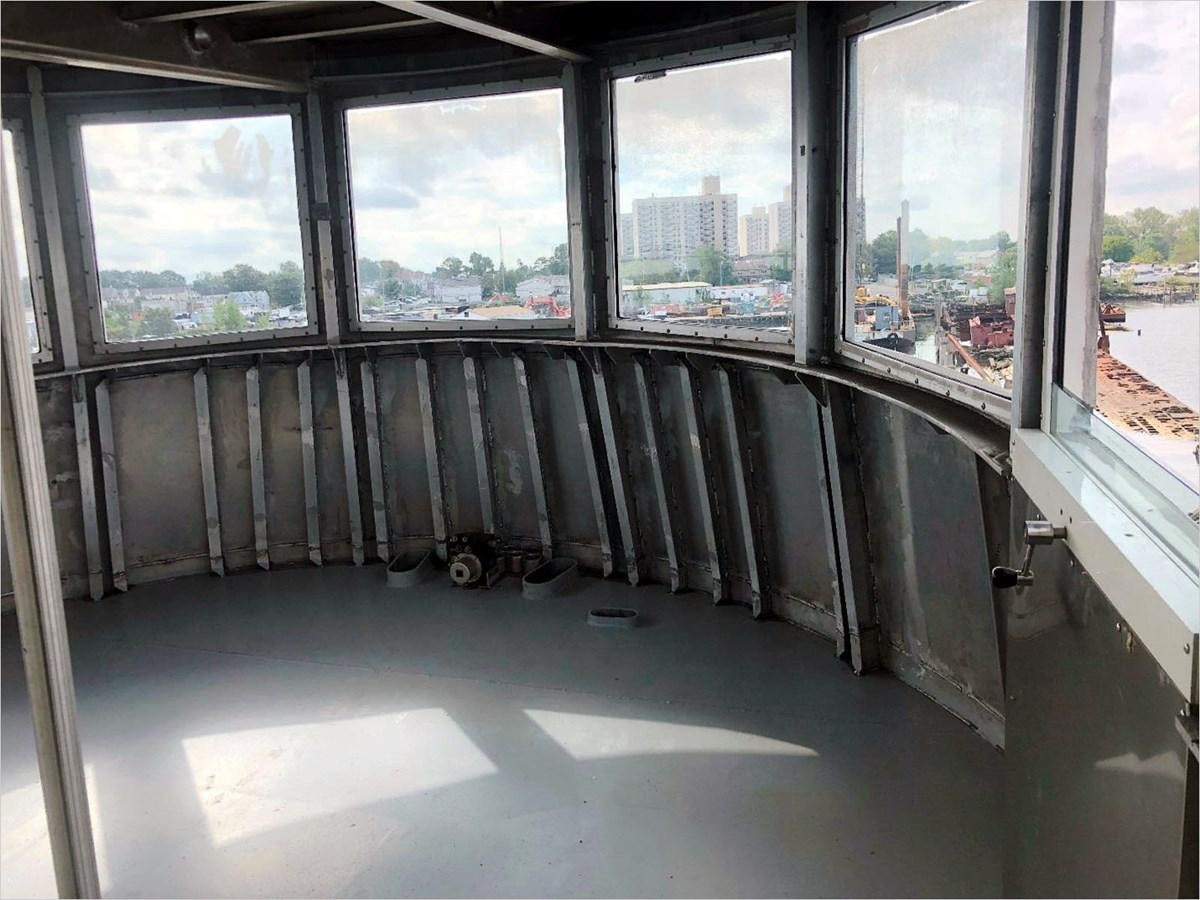 a deck with a railing and a railing with windows and a view of the city aboard SEA MONSTER Yacht for Sale