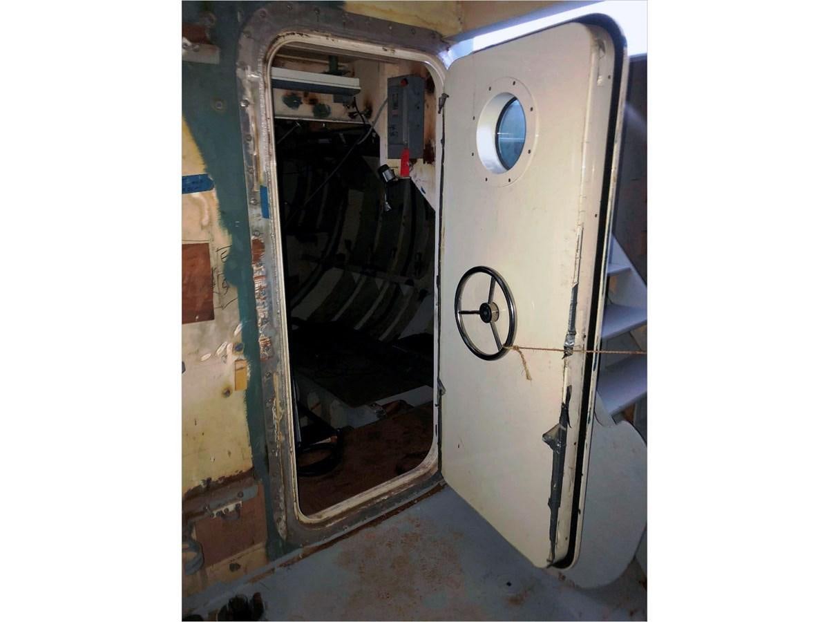 a door open with a hole in it aboard SEA MONSTER Yacht for Sale