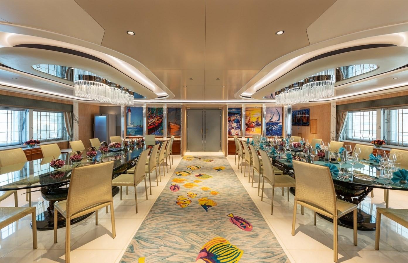 a room with tables and chairs aboard MOONLIGHT II Yacht for Sale