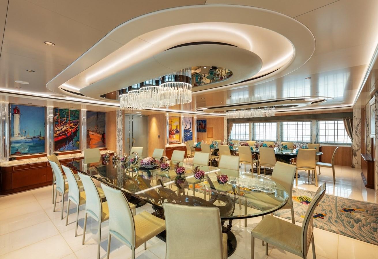 a room with tables and chairs aboard MOONLIGHT II Yacht for Sale