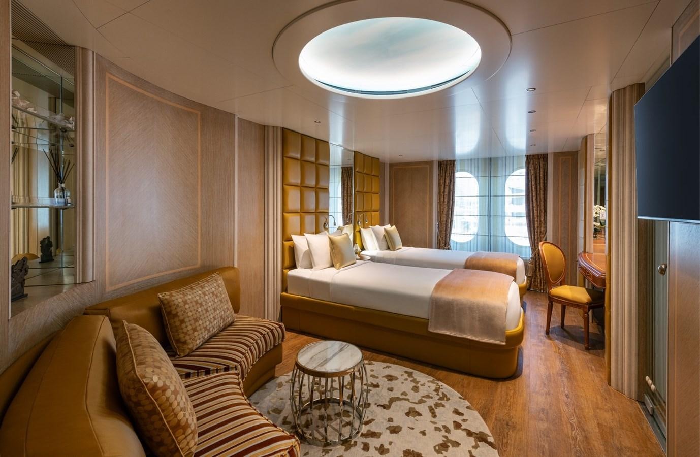 a hotel room with a bed and a couch aboard MOONLIGHT II Yacht for Sale