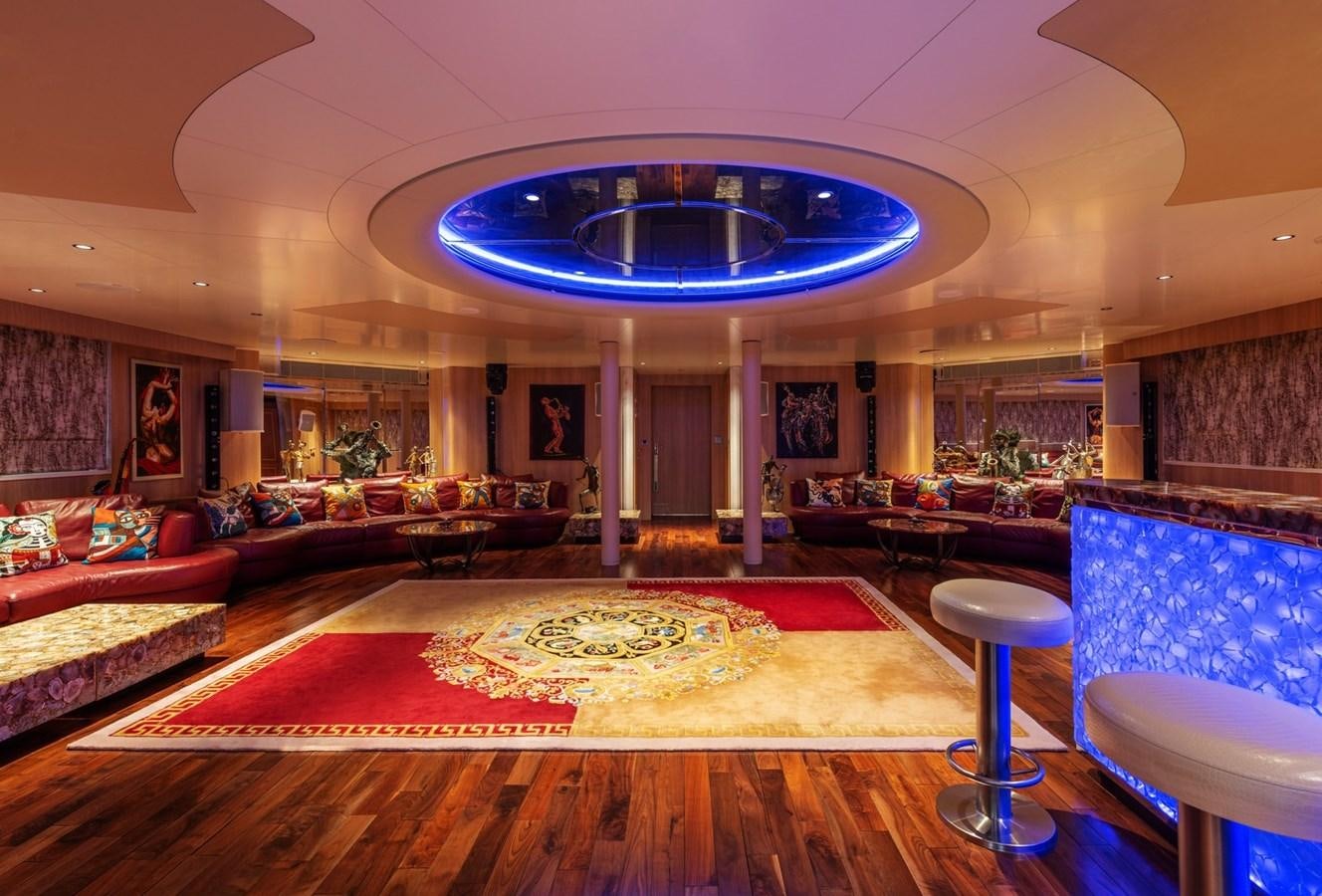a large living room with a large chandelier aboard MOONLIGHT II Yacht for Sale