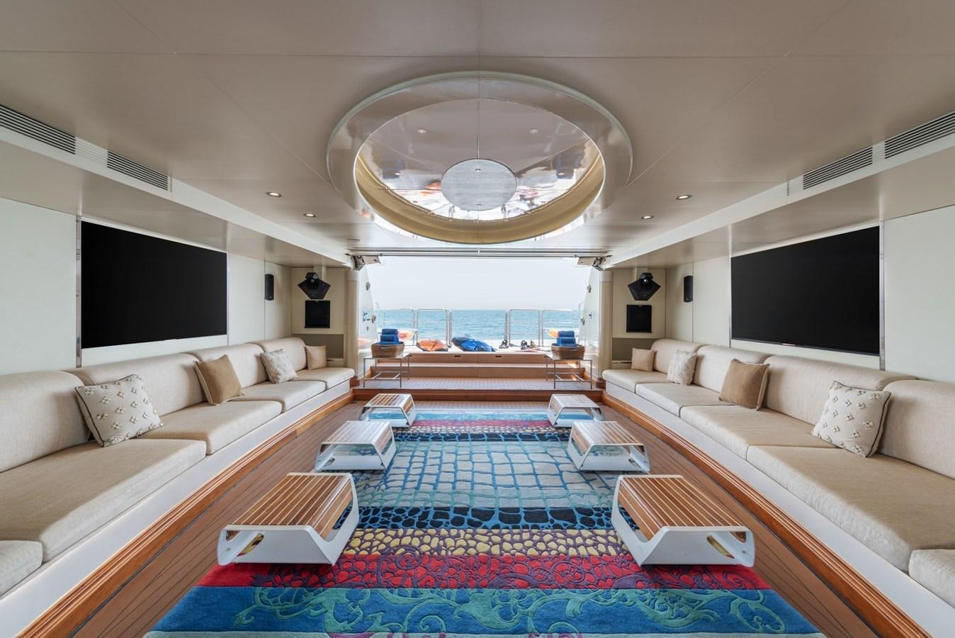 a large living room with a large chandelier aboard MOONLIGHT II Yacht for Sale