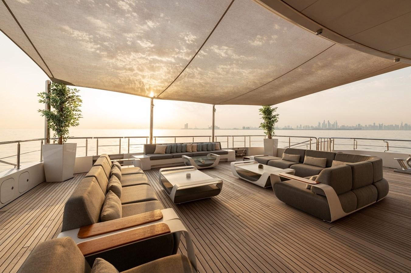 a large room with couches and a large window aboard MOONLIGHT II Yacht for Sale