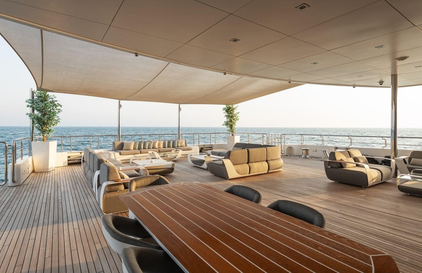 a large living room with a large balcony overlooking the ocean aboard MOONLIGHT II Yacht for Sale