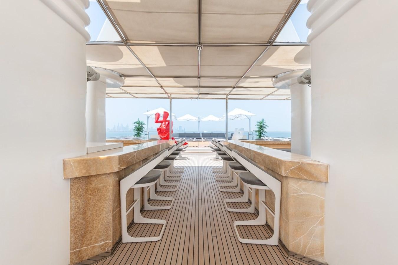 a long wooden walkway with benches aboard MOONLIGHT II Yacht for Sale