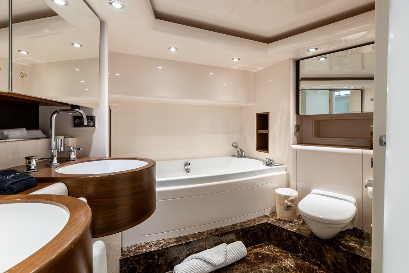 a bathroom with a tub sink and toilet aboard GRANDEUR Yacht for Sale