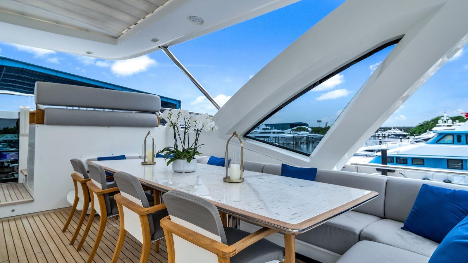 a room with a table and chairs aboard ONE & ONLY Yacht for Sale
