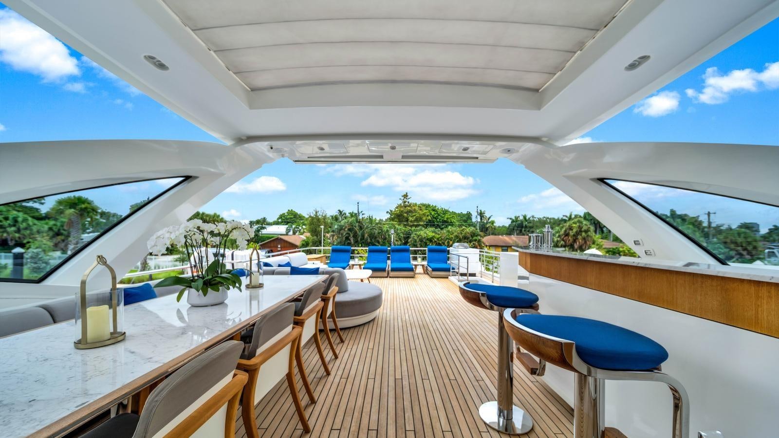 a large white boat with tables and chairs aboard ONE & ONLY Yacht for Sale