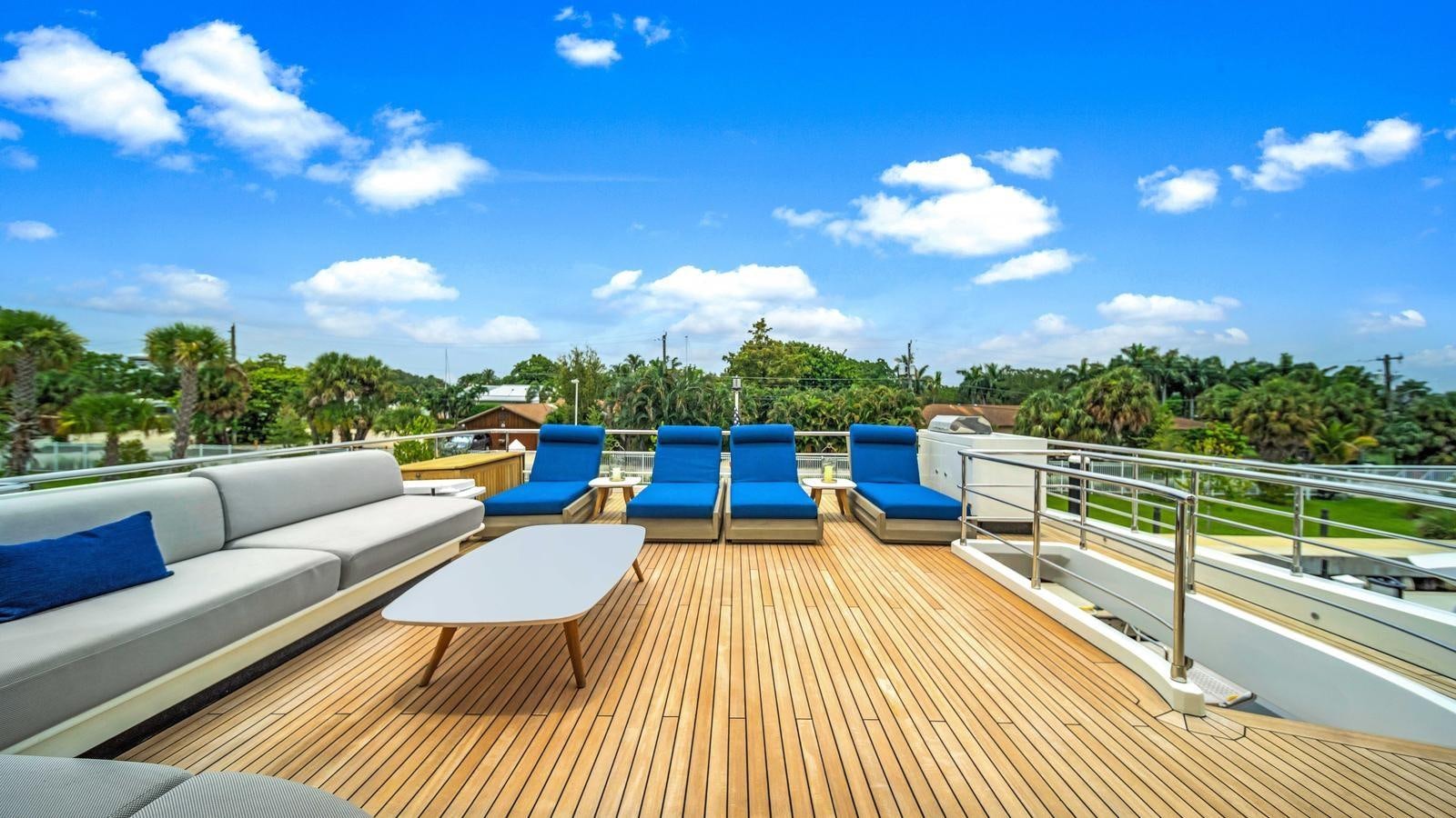 a deck with chairs and tables on it aboard ONE & ONLY Yacht for Sale