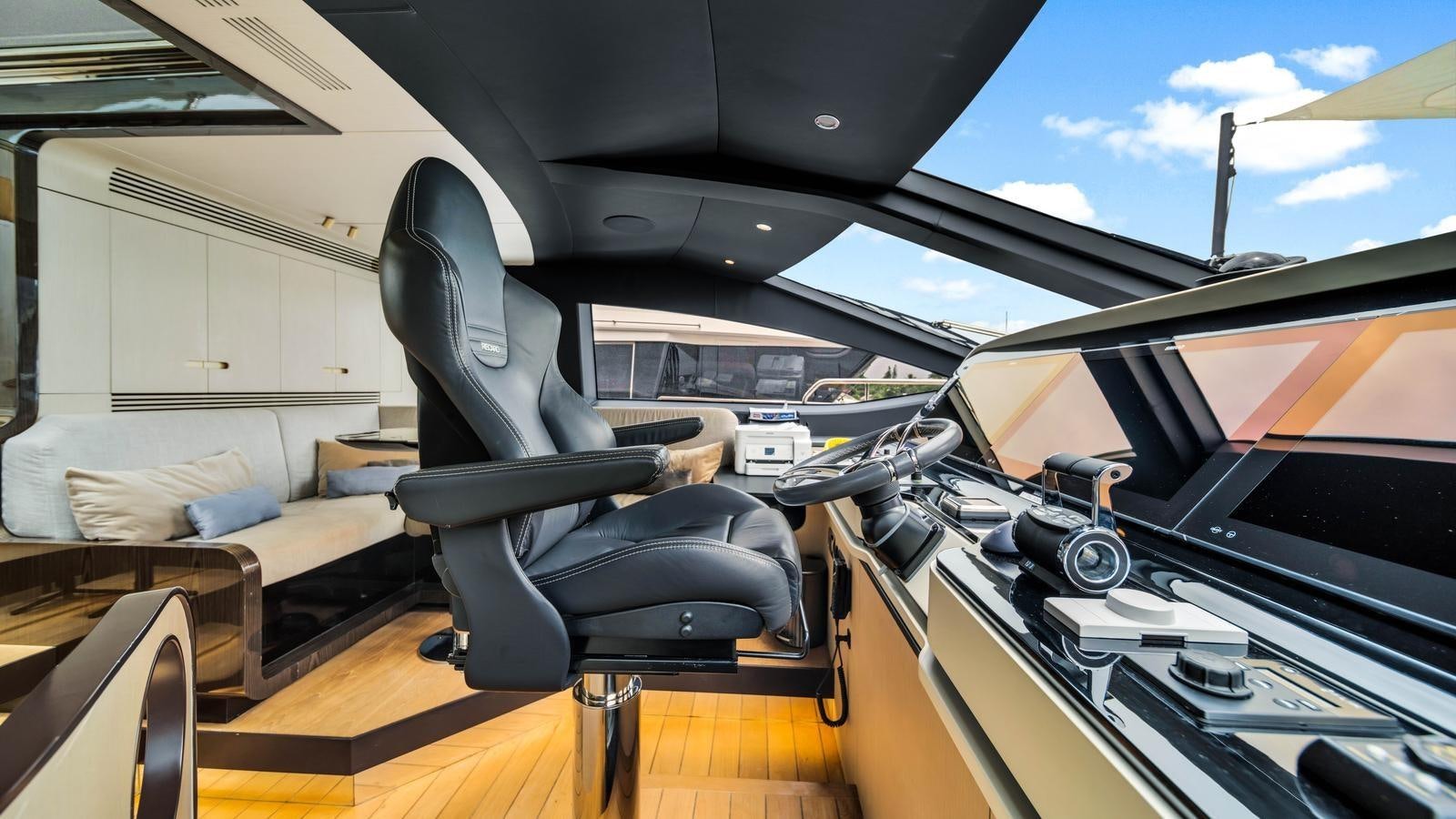 a car with a seat and a desk in the back aboard ONE & ONLY Yacht for Sale