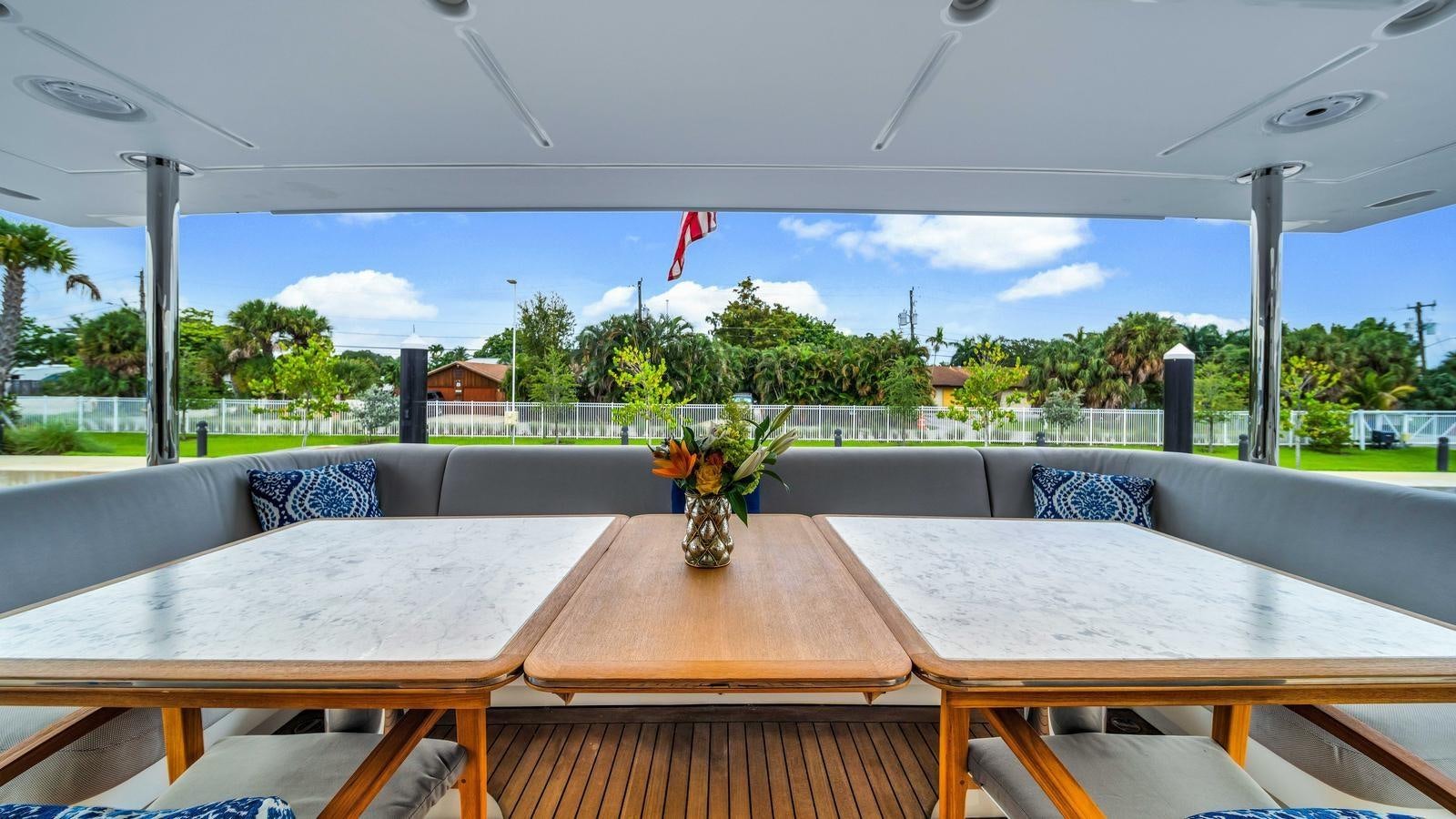 a table with a vase of flowers on it aboard ONE & ONLY Yacht for Sale