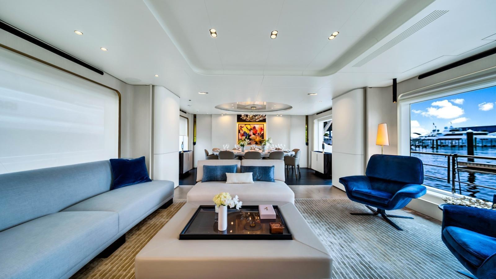 a living room with a large window aboard ONE & ONLY Yacht for Sale
