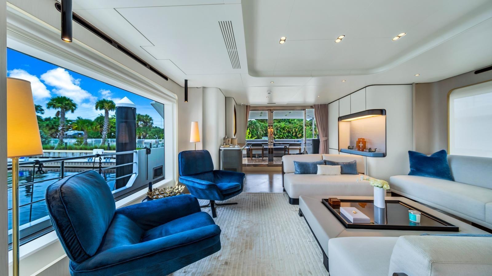 a living room with a large window aboard ONE & ONLY Yacht for Sale