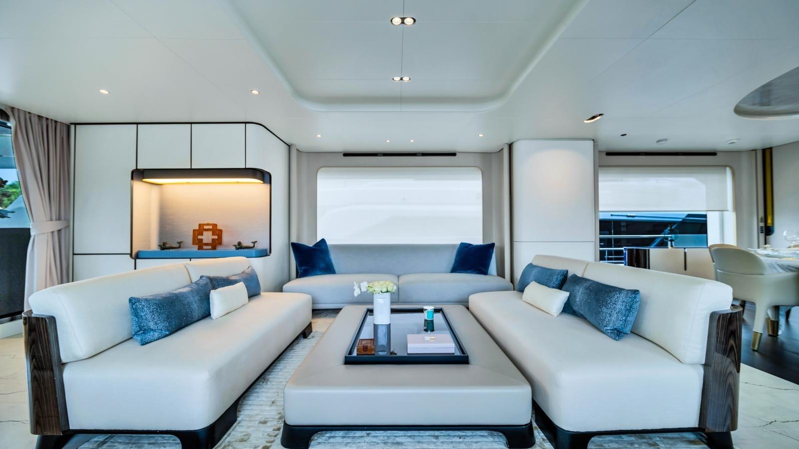 a living room with a couch and a table aboard ONE & ONLY Yacht for Sale